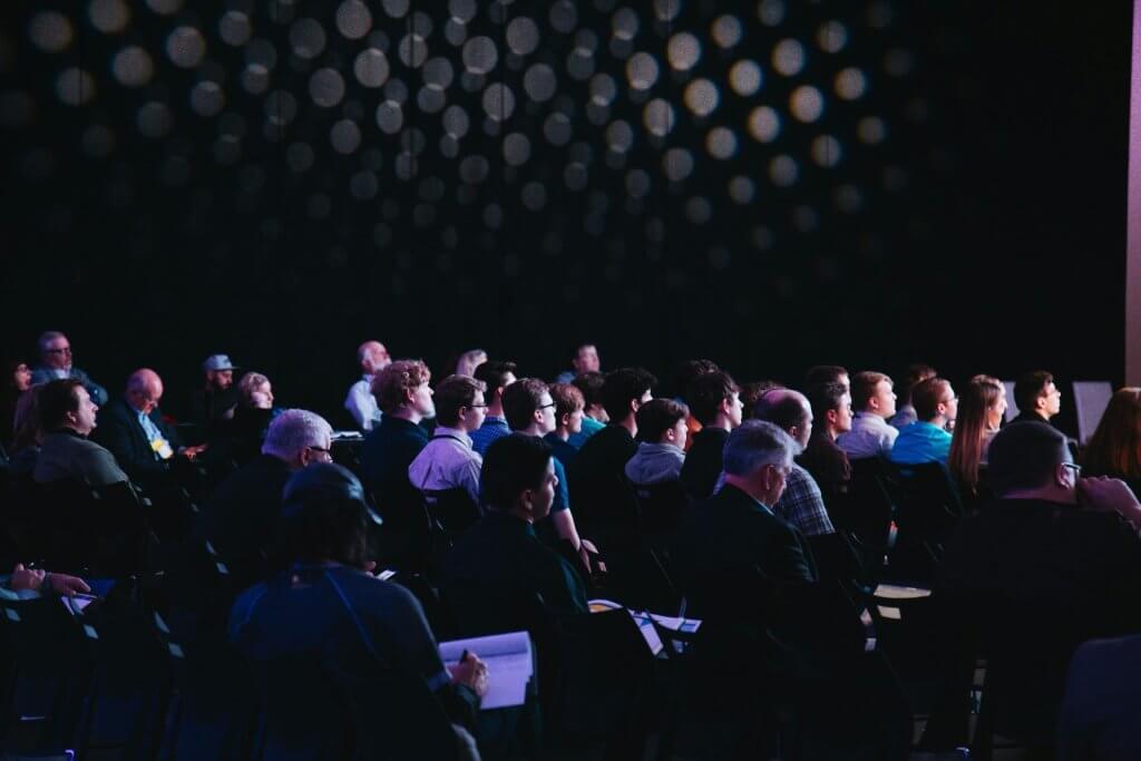 Participants at an educational event on trends, attentively taking notes.