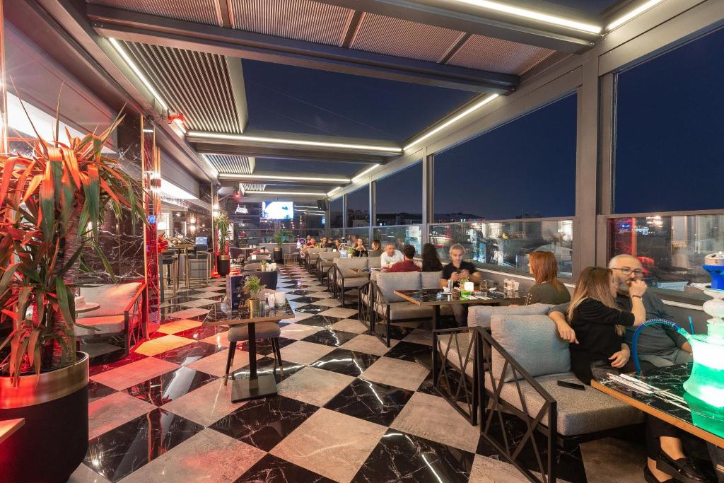 Grand Washington Hotel - people sitting at tables in a restaurant with a view at Grand Washington Hotel in Istanbul