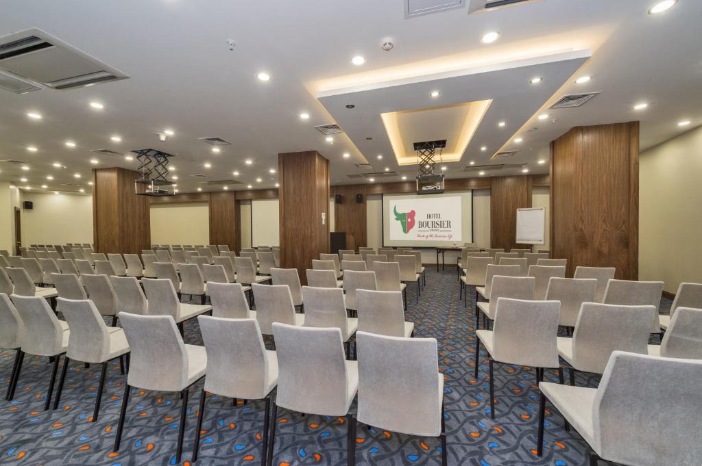 Hotel Boursier 1 & Spa - a conference room with rows of chairs and a screen at Hotel Boursier 1 &amp; Spa in Istanbul