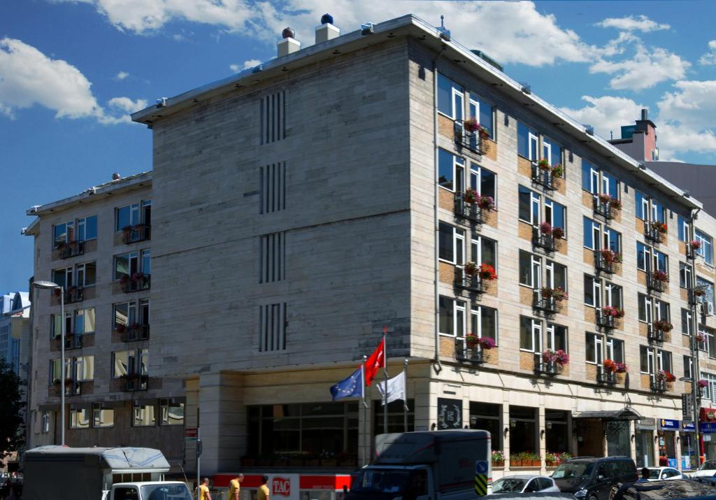 Hotel Buyuk Keban - a large building with cars parked in front of it at Hotel Buyuk Keban in Istanbul