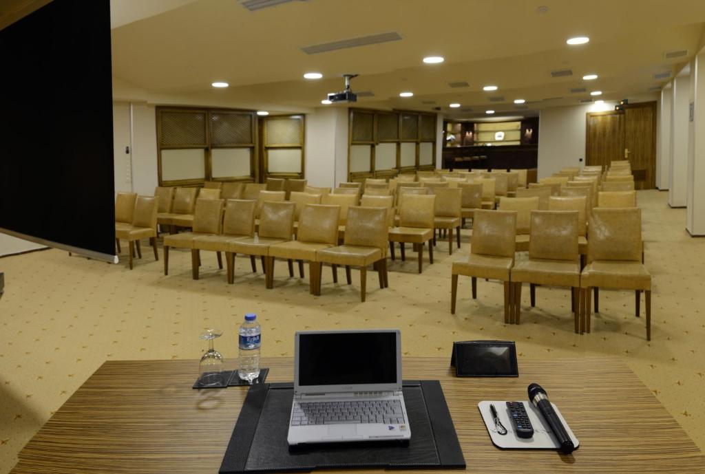Hotel Buyuk Keban - a conference room with a laptop on a table and chairs at Hotel Buyuk Keban in Istanbul