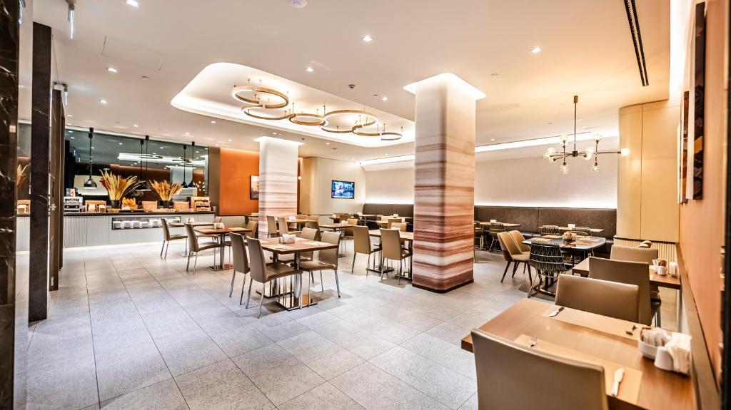 Lamartine Hotel - a restaurant with tables and chairs and a counter at Lamartine Hotel in Istanbul