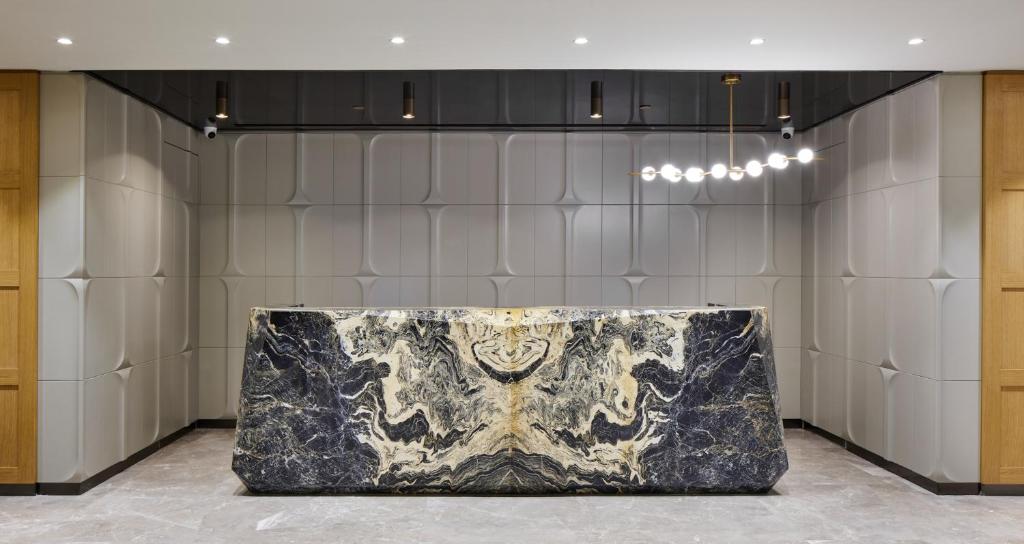 Lamartine Hotel - a lobby with a marble table in the middle at Lamartine Hotel in Istanbul