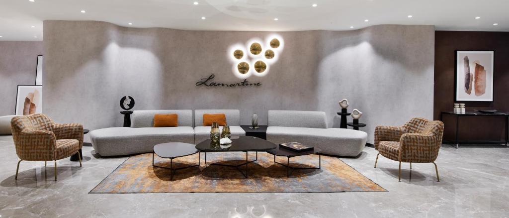 Lamartine Hotel - a living room with a couch and chairs and a table at Lamartine Hotel in Istanbul