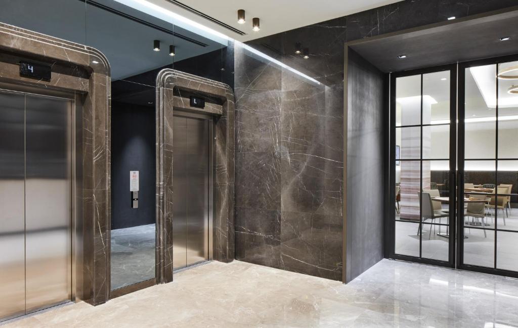Lamartine Hotel - a lobby with black walls and glass doors at Lamartine Hotel in Istanbul