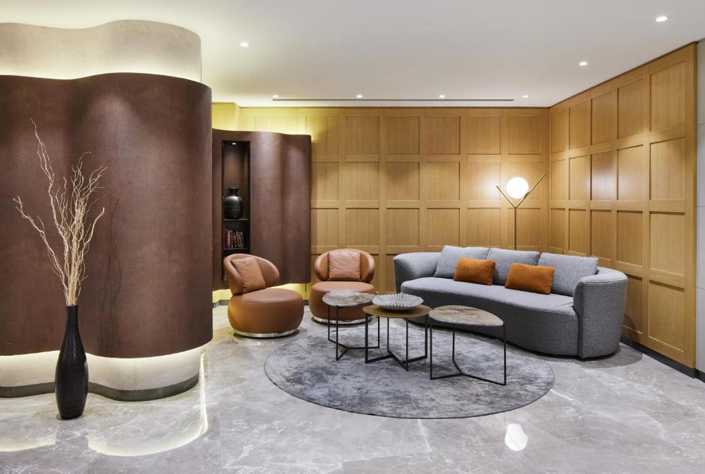 Lamartine Hotel - a living room with a couch and two chairs at Lamartine Hotel in Istanbul