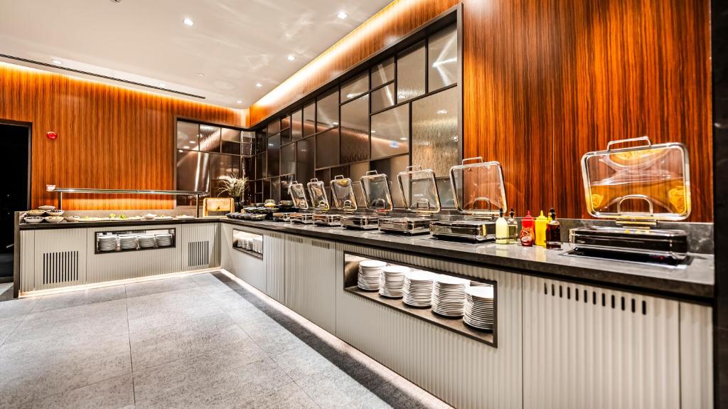 Lamartine Hotel - a restaurant kitchen with a counter with dishes at Lamartine Hotel in Istanbul