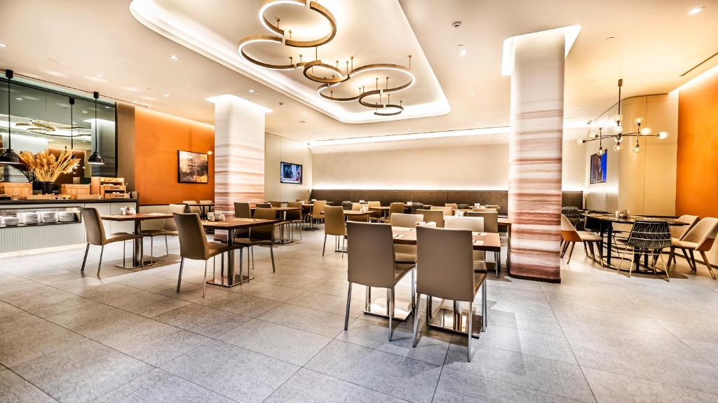 Lamartine Hotel - a dining room with tables and chairs in a restaurant at Lamartine Hotel in Istanbul