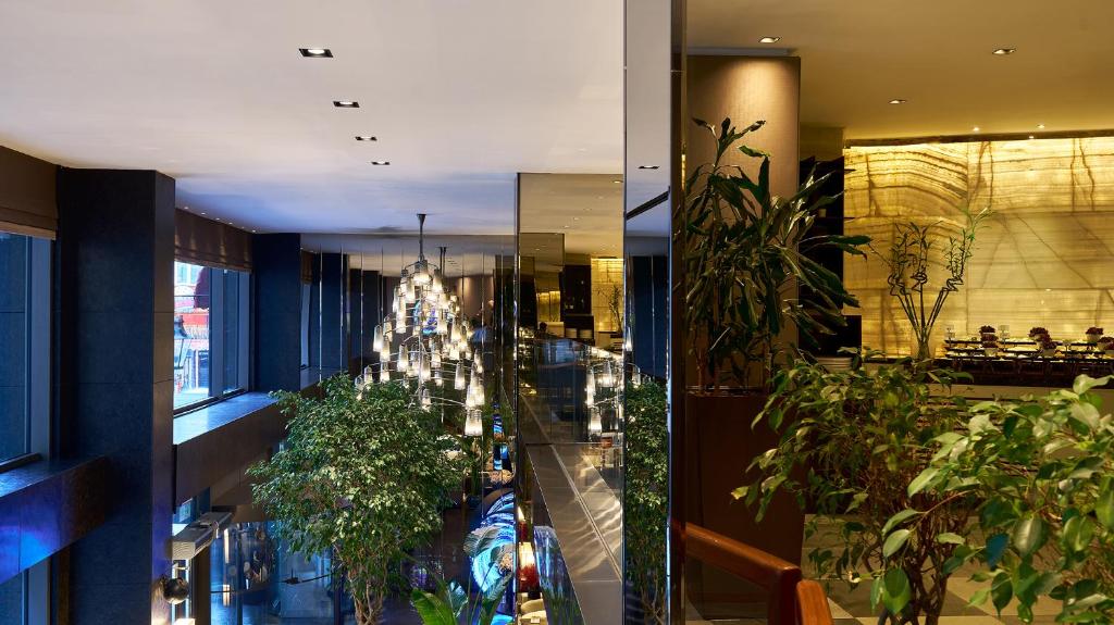 Lasagrada Hotel Istanbul - a lobby with plants and a building with a christmas tree at Lasagrada Hotel Istanbul in Istanbul