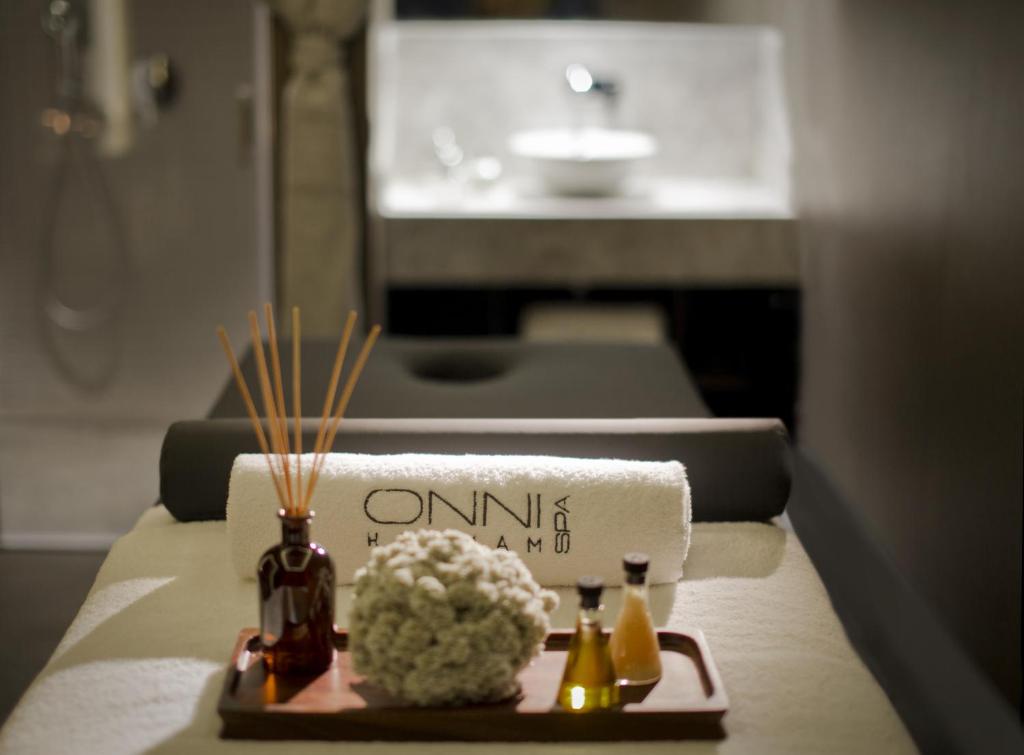 Lazzoni Hotel - a table with a towel and flowers on a table at Lazzoni Hotel in Istanbul
