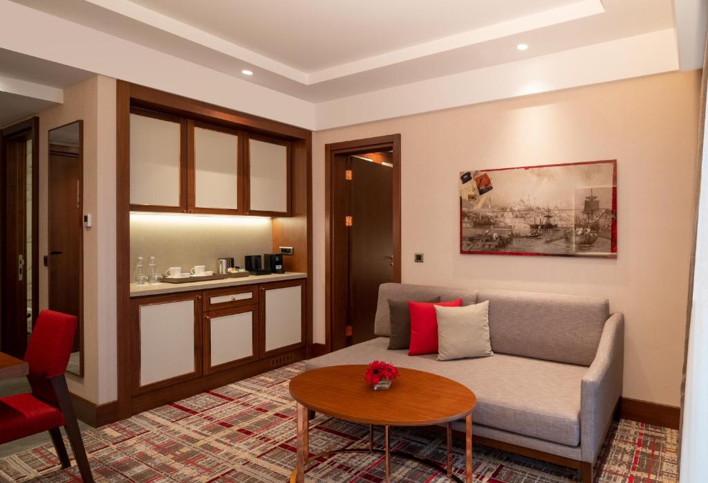 Mövenpick Hotel Istanbul Asia Airport - a living room with a couch and a table at Mövenpick Hotel Istanbul Asia Airport in Istanbul