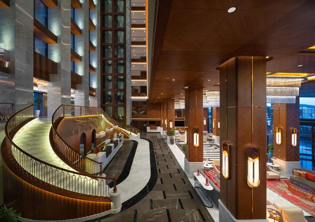 Mövenpick Hotel Istanbul Asia Airport - a lobby of a hotel with a spiral staircase at Mövenpick Hotel Istanbul Asia Airport in Istanbul