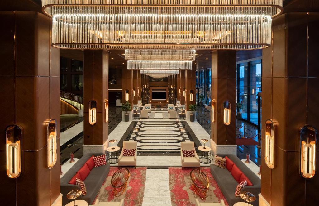 Mövenpick Hotel Istanbul Asia Airport - a view of a hotel lobby with a large chandelier at Mövenpick Hotel Istanbul Asia Airport in Istanbul