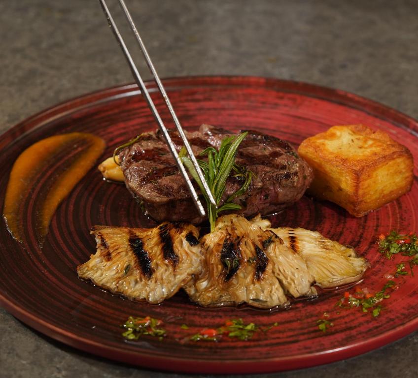 Mövenpick Hotel Istanbul Asia Airport - a red plate of food with meat and a banana at Mövenpick Hotel Istanbul Asia Airport in Istanbul