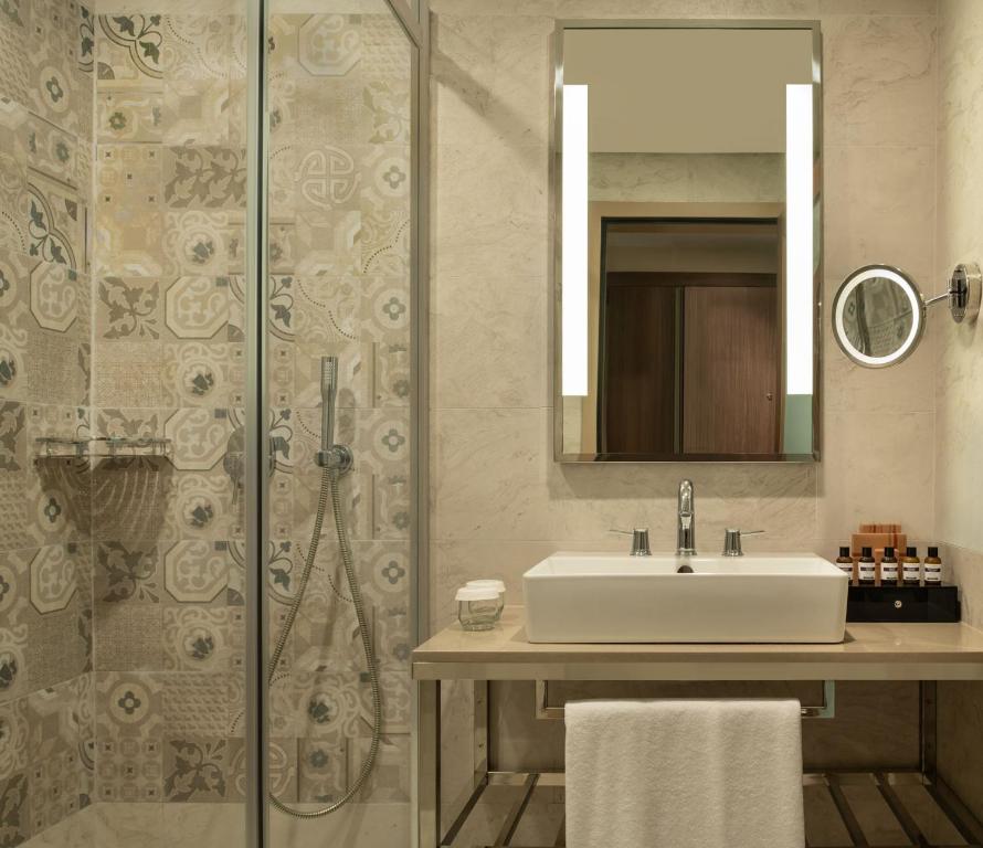 Mövenpick Hotel Istanbul Asia Airport - a bathroom with a sink and a shower at Mövenpick Hotel Istanbul Asia Airport in Istanbul
