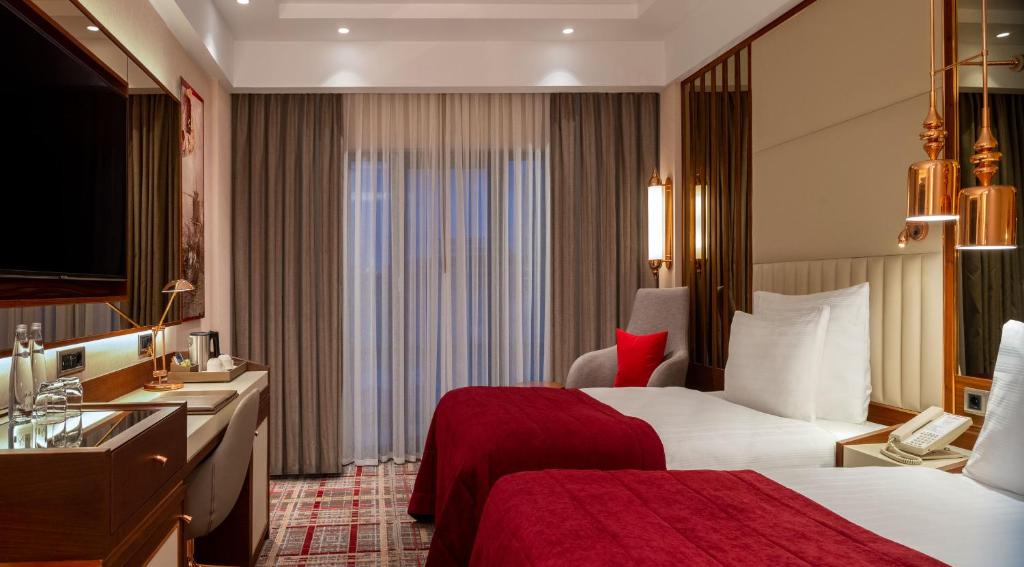 Mövenpick Hotel Istanbul Asia Airport - a hotel room with a bed and a sink at Mövenpick Hotel Istanbul Asia Airport in Istanbul