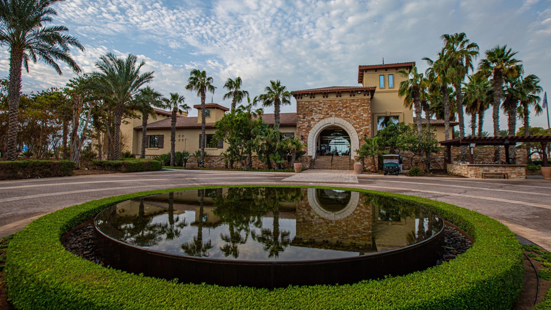 Saadiyat Beach Golf Club entrance with palm trees, Dubai venue.