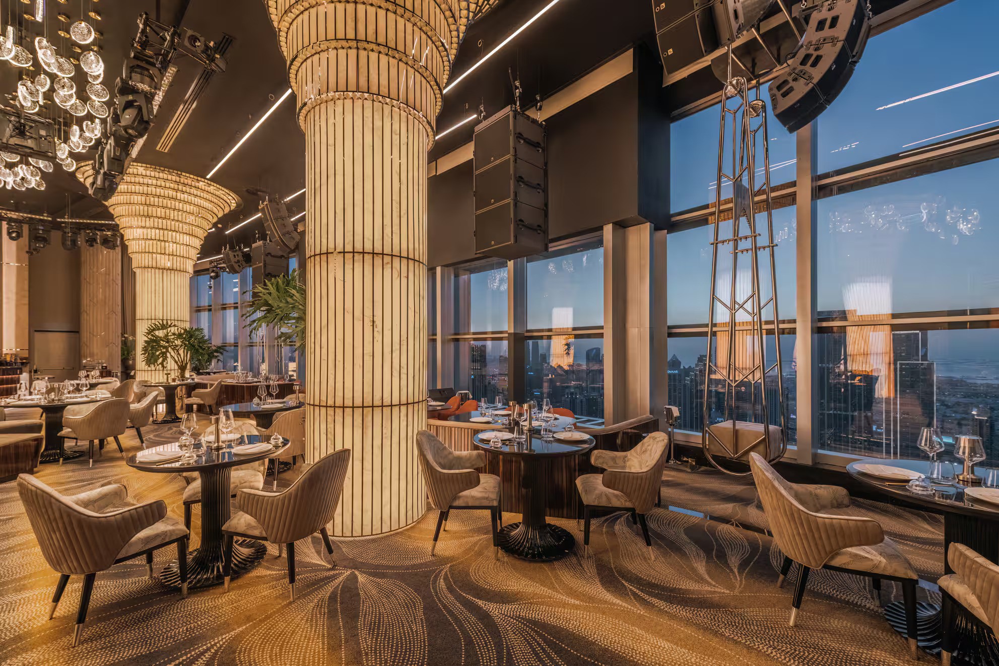 Elegant interior of Birds Dubai venue with city skyline view.