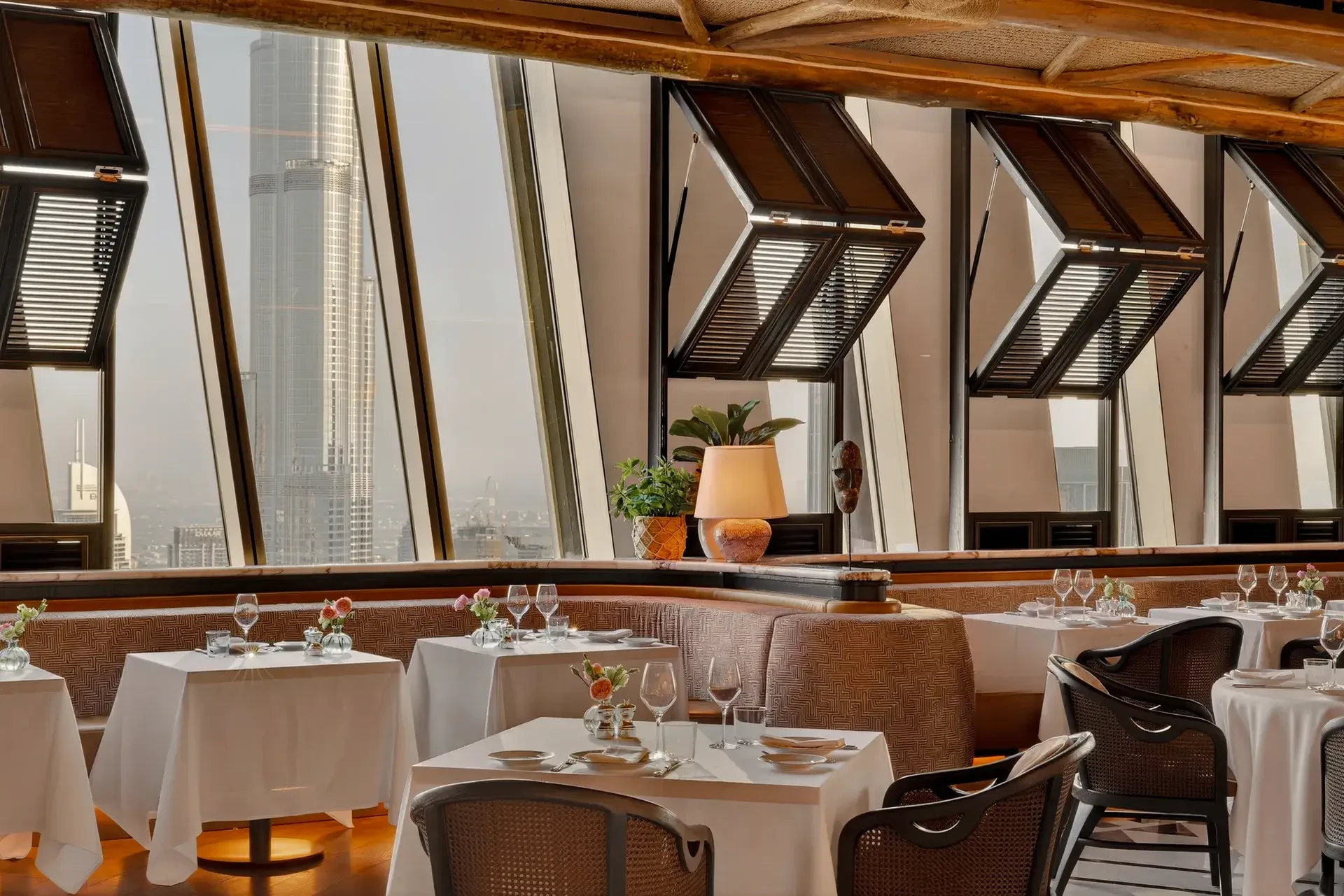 Elegant dining area at Lion in the Sun Dubai with city view.