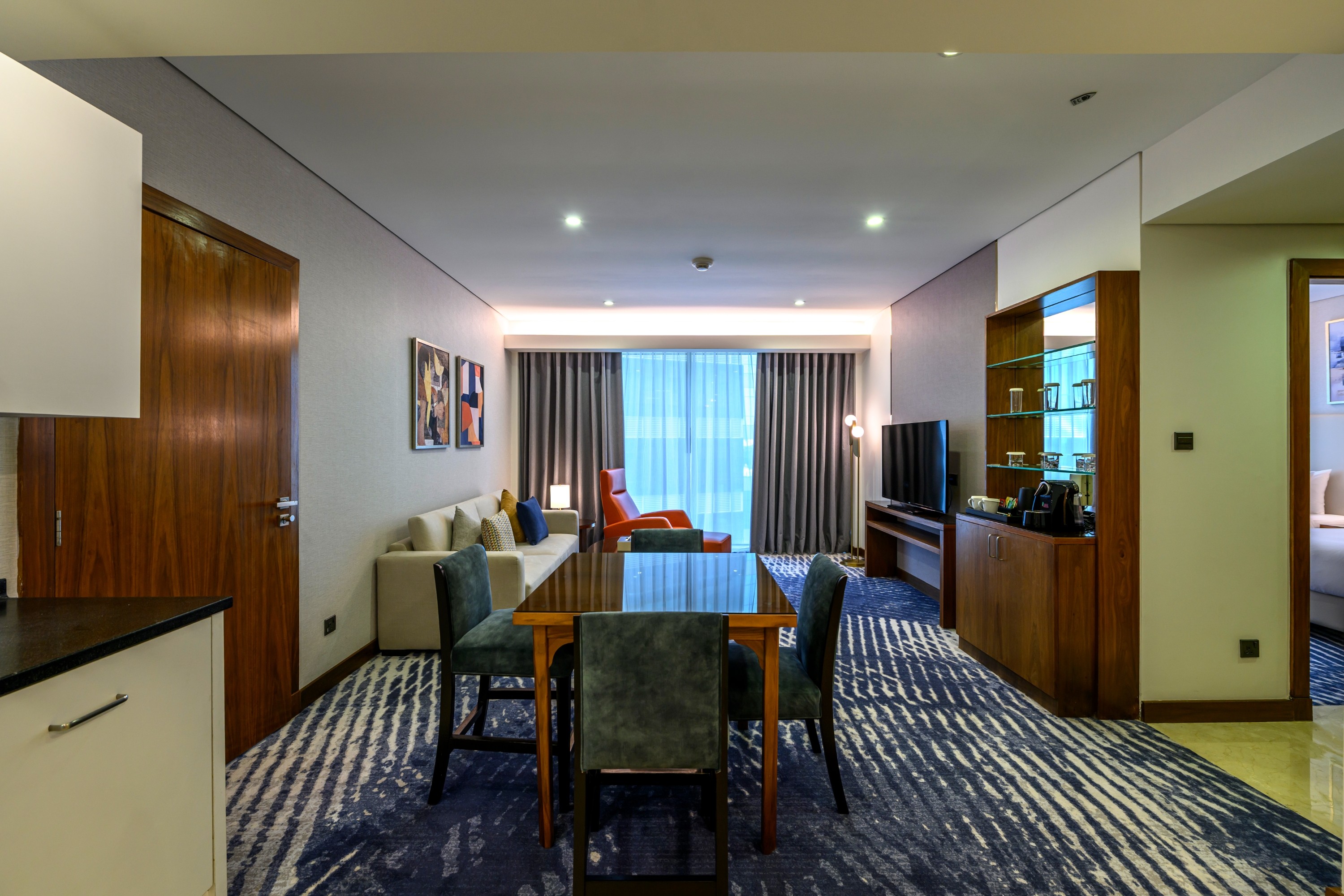 Spacious guest room with modern decor and seating area.