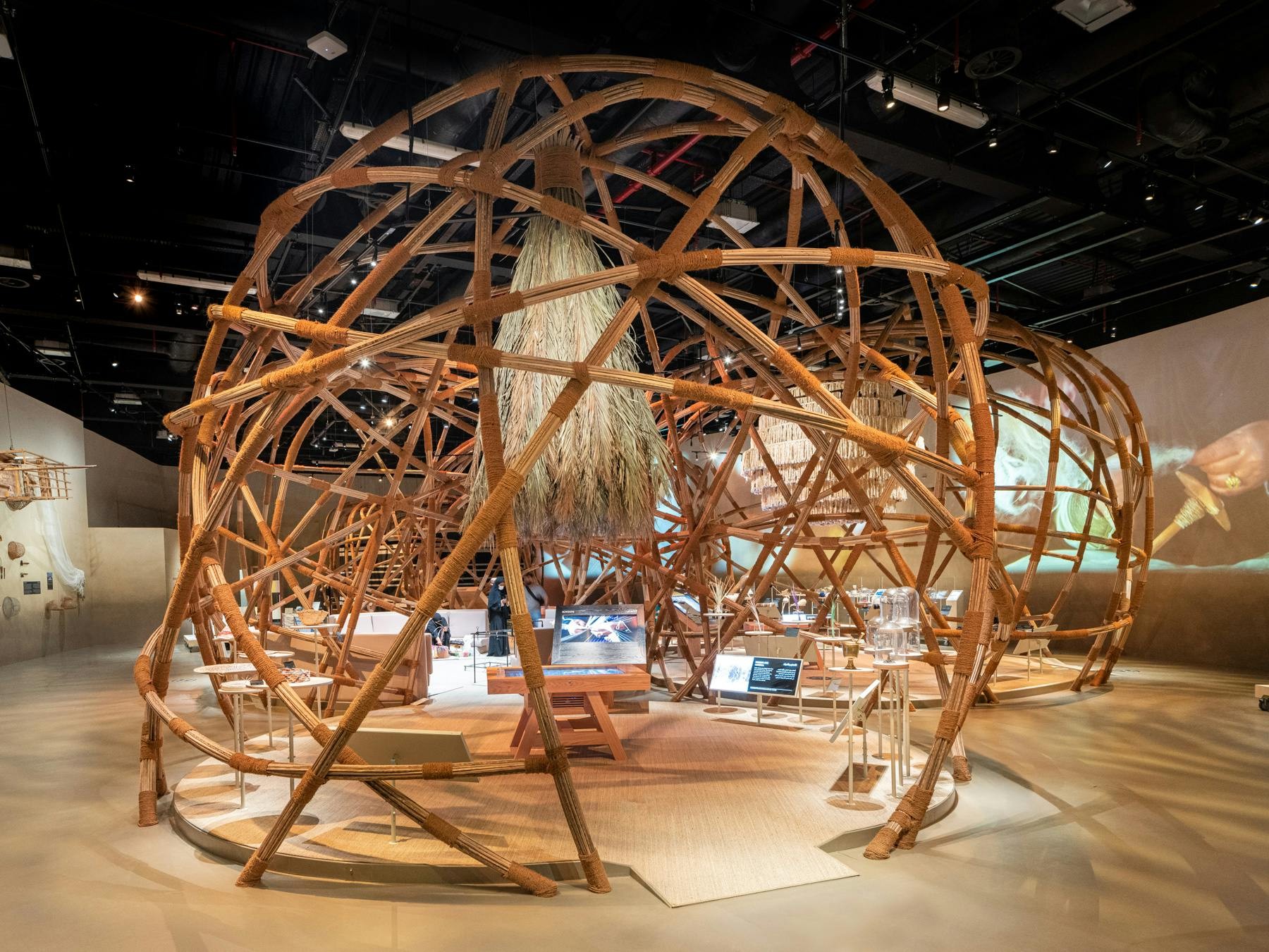 Intricate wooden structure inside House of Artisans, Dubai exhibition space.