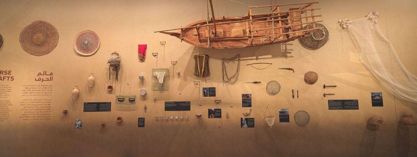 House of Artisans exhibition wall with traditional crafts, Dubai venue.