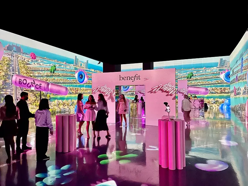 Arte Museum Dubai interior with vibrant digital displays and attendees.