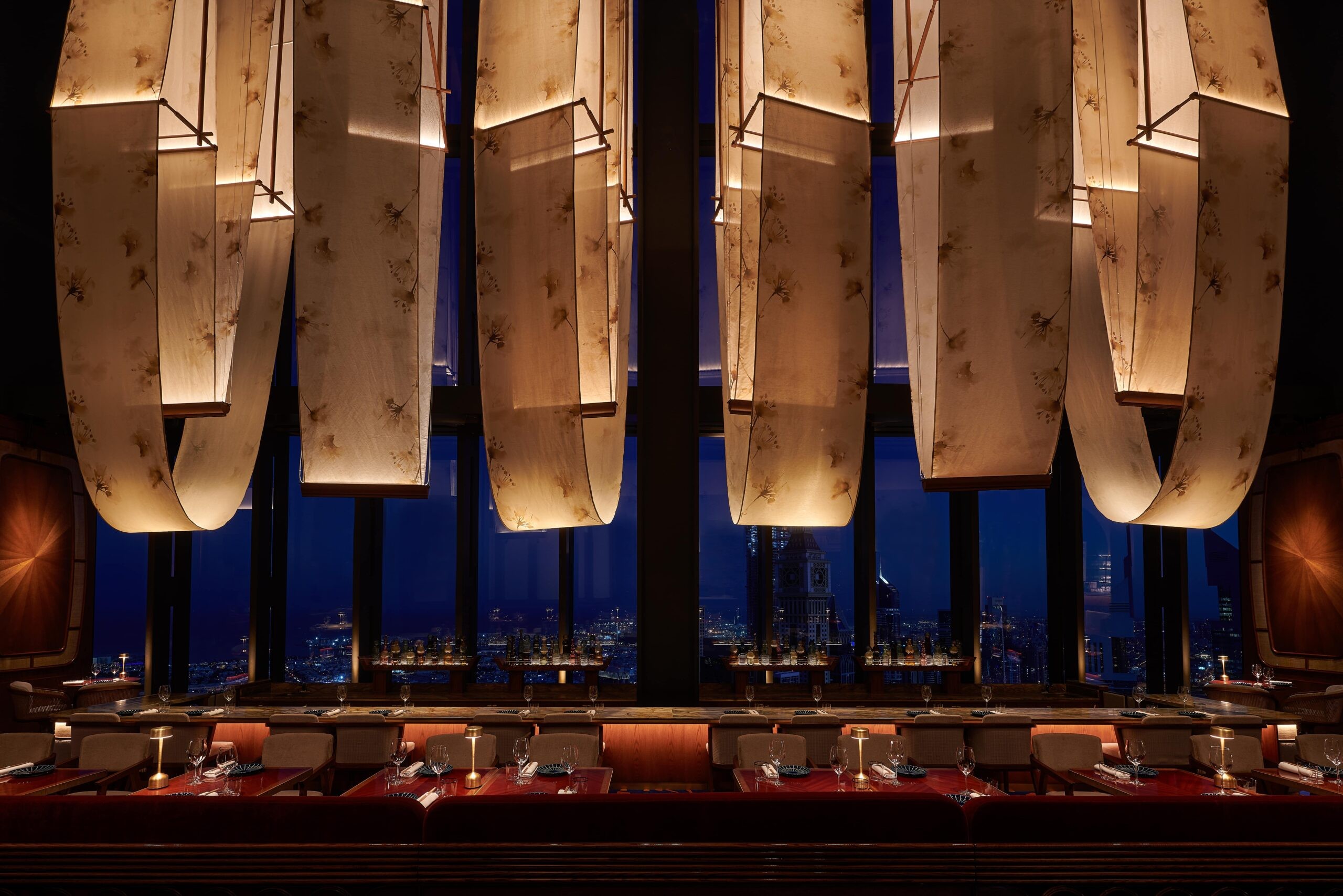 Elegant interior of Bar des Pres Dubai with city skyline view.
