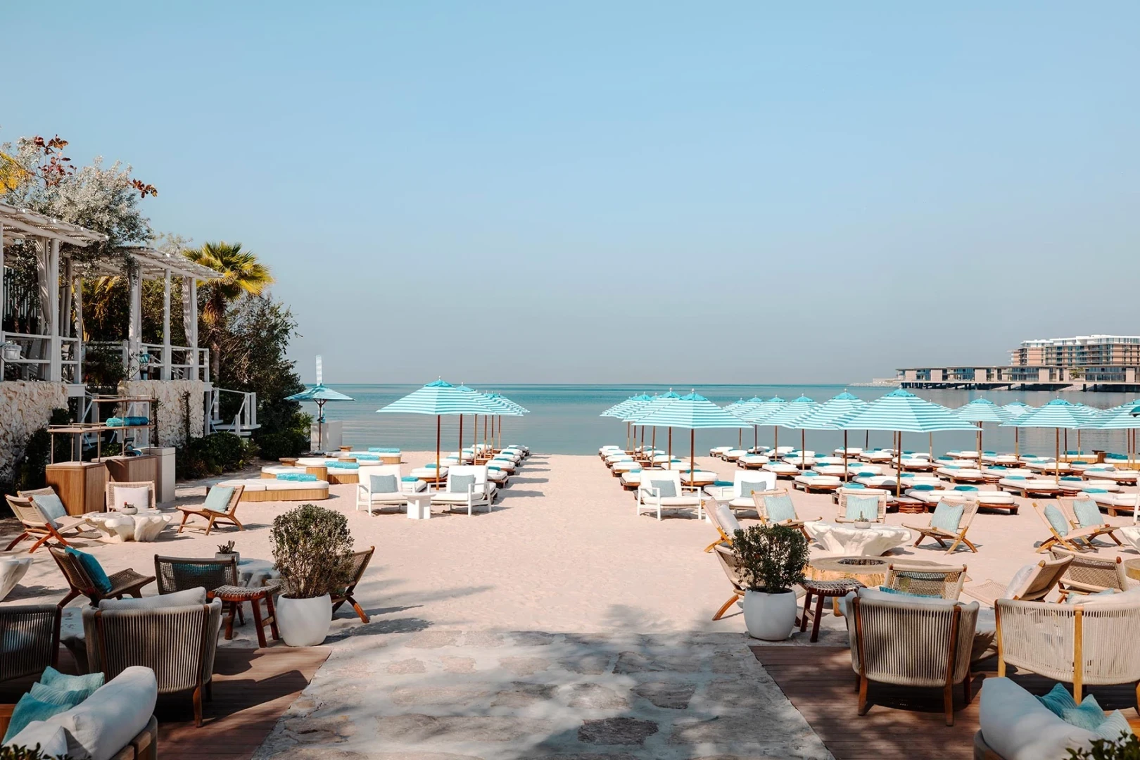 Nammos Dubai beachfront venue with umbrellas and seating, ideal for events.