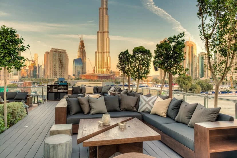 Treehouse, Taj Dubai rooftop lounge with Burj Khalifa view at sunset.