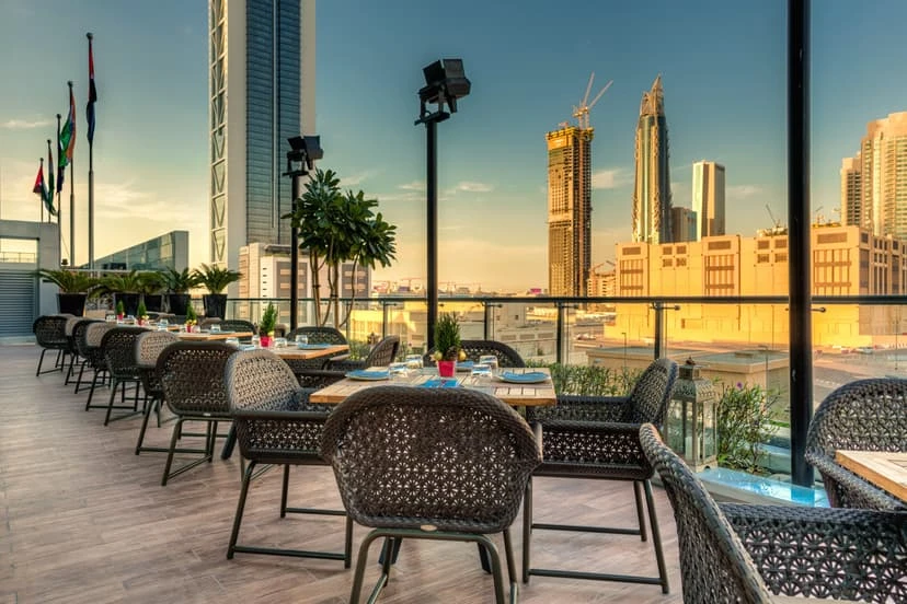 Treehouse, Taj Dubai terrace with city skyline view at sunset.