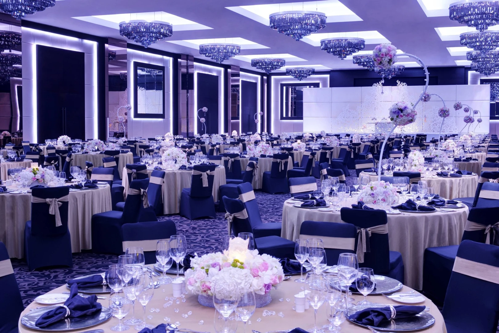 Elegant banquet hall at JW Marriott Marquis Hotel Dubai, beautifully decorated tables.