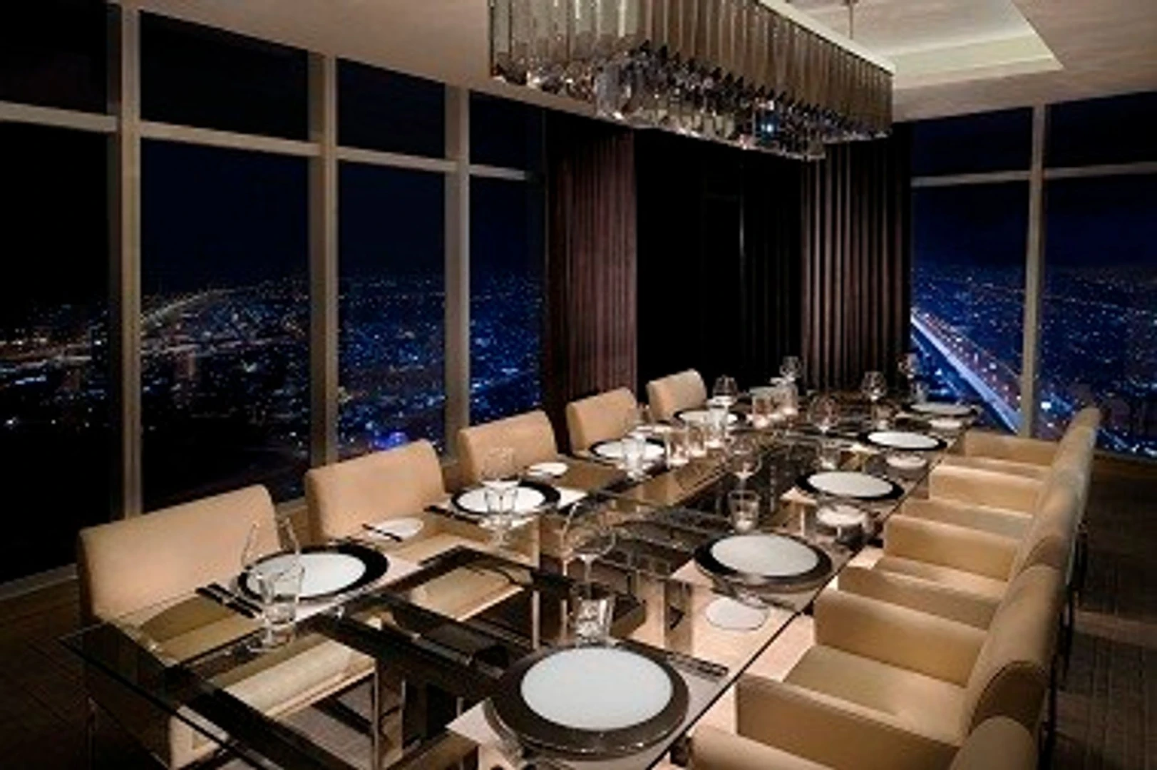 Elegant dining room at JW Marriott Marquis Hotel Dubai, night city view.