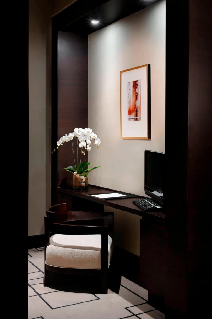Elegant workspace at JW Marriott Marquis Hotel Dubai with orchid decoration.