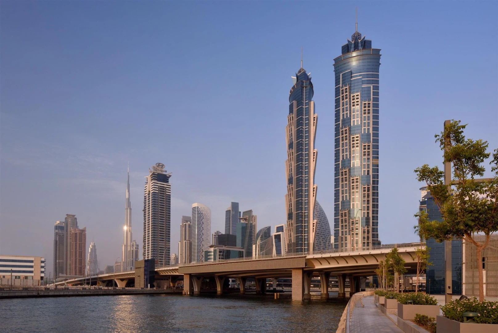JW Marriott Marquis Hotel Dubai skyline view, waterfront, clear sky.