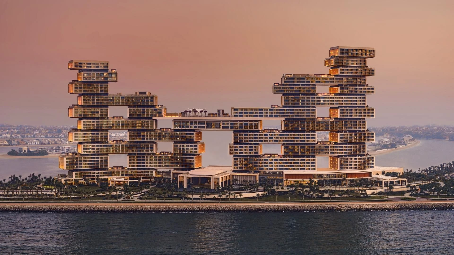 Atlantis The Royal Dubai, modern architecture at sunset by the sea.