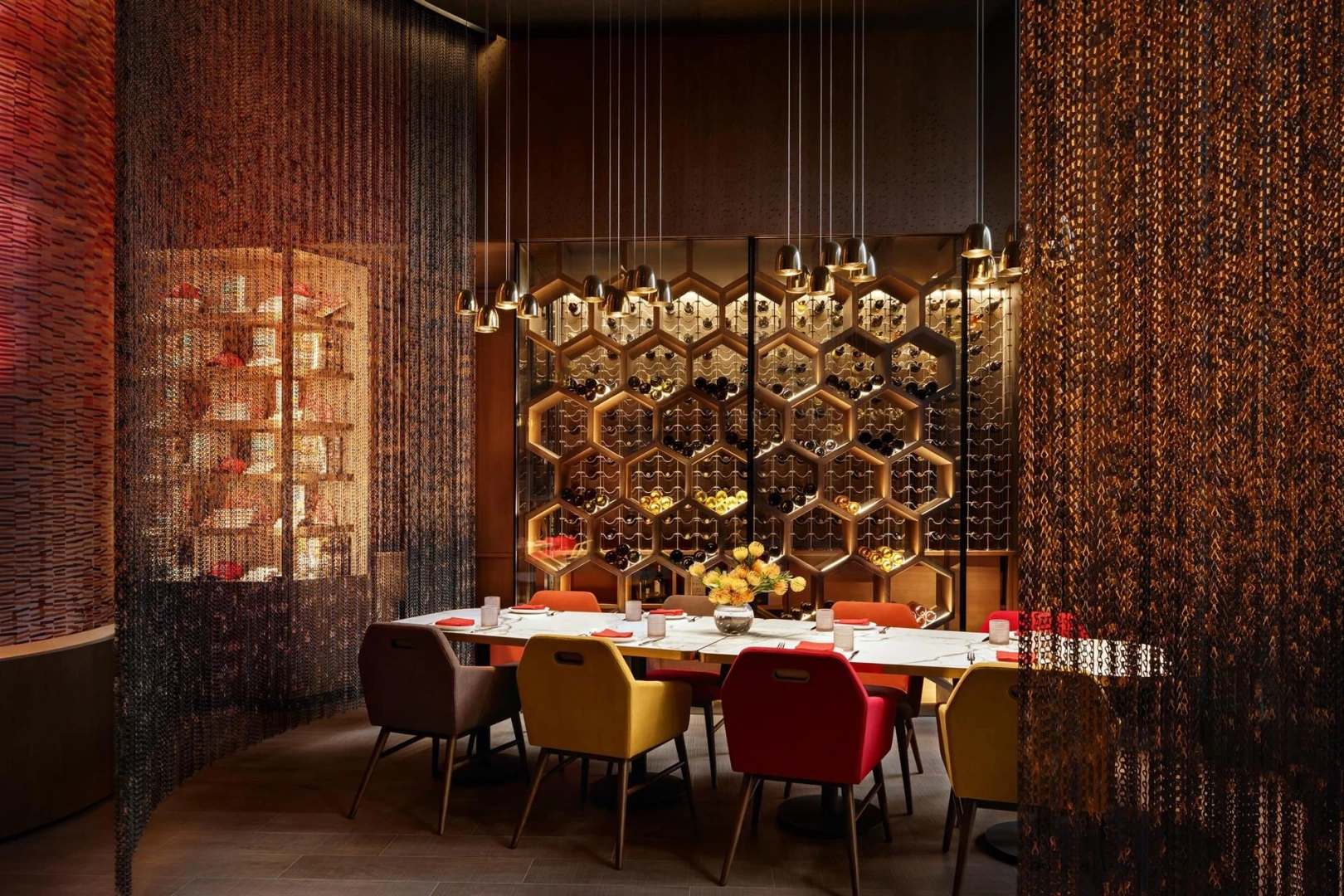 Elegant dining area at Atlantis The Royal, Dubai with hexagonal wine display.