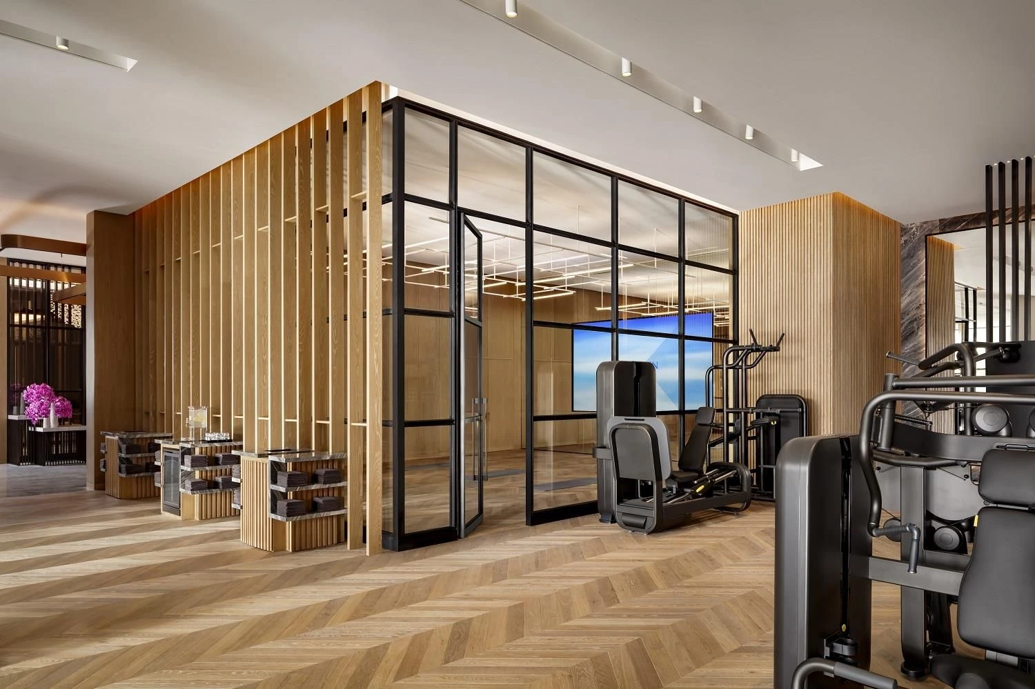 Modern gym at Atlantis The Royal, Dubai with wooden accents.