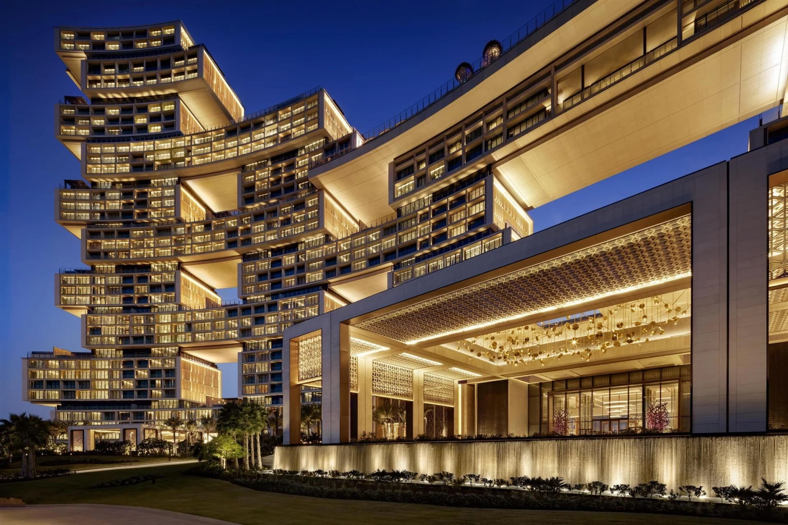 Illuminated Atlantis The Royal Dubai at night with modern architecture.