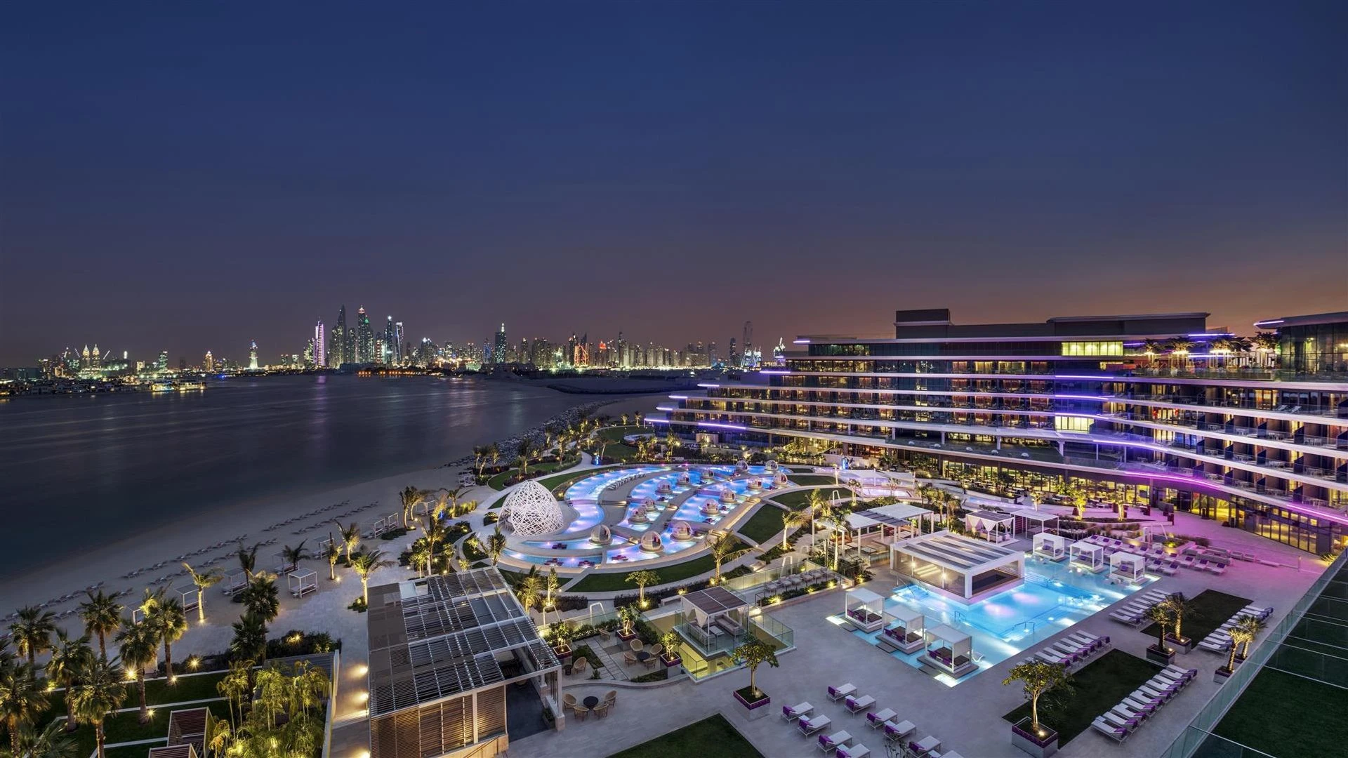 W Dubai - The Palm, illuminated at night with city skyline view.