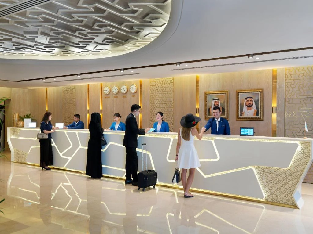 Guests at reception, Two Seasons Hotel & Apartments Dubai lobby.