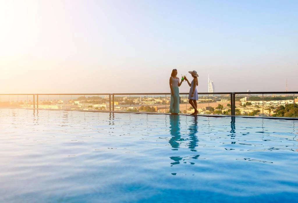 Two women by rooftop pool at Two Seasons Hotel Dubai.