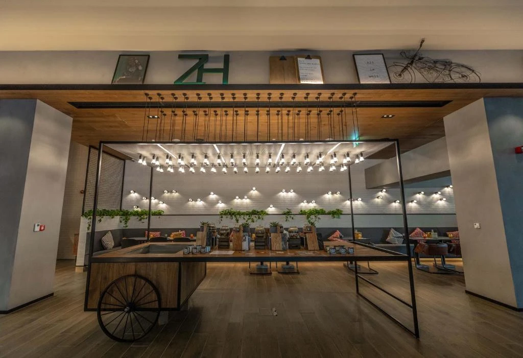 Modern interior of Zabeel House The Greens, Dubai, with hanging lights.