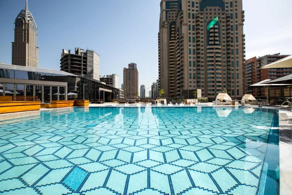 Rooftop pool at Zabeel House The Greens, Dubai, with city skyline.