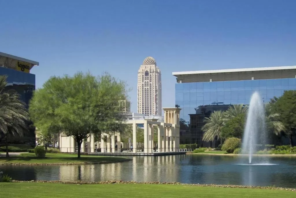 Arjaan by Rotana, Dubai Media City, with fountain and greenery.