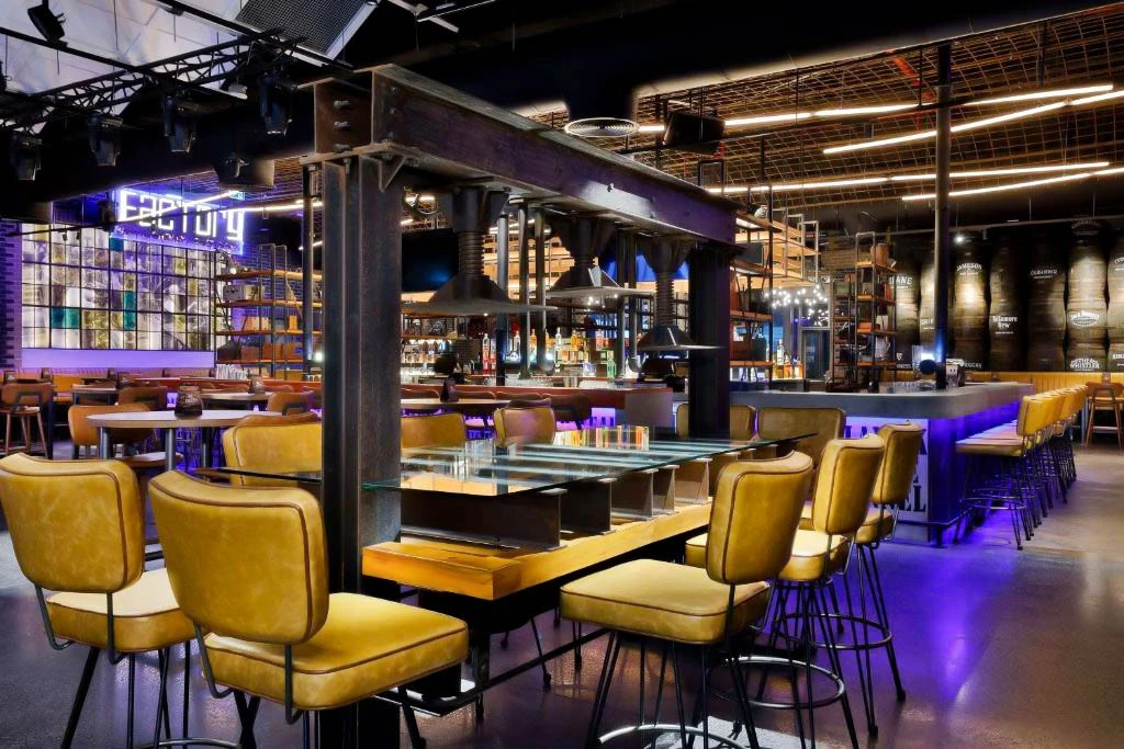 Modern restaurant interior at Hilton Dubai Palm Jumeirah, vibrant lighting.