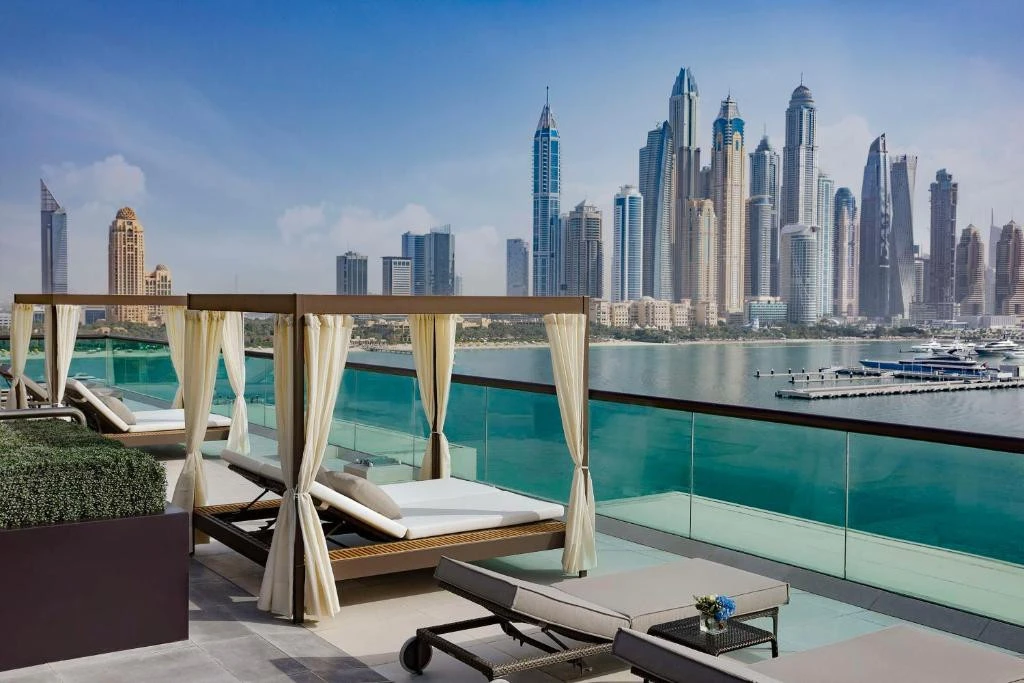 Hilton Dubai Palm Jumeirah terrace with city skyline view.
