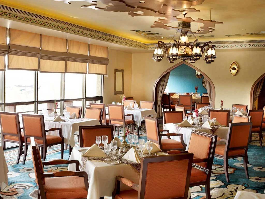 Chic dining room with ornate chandelier, Radisson Blu Hotel, Dubai.