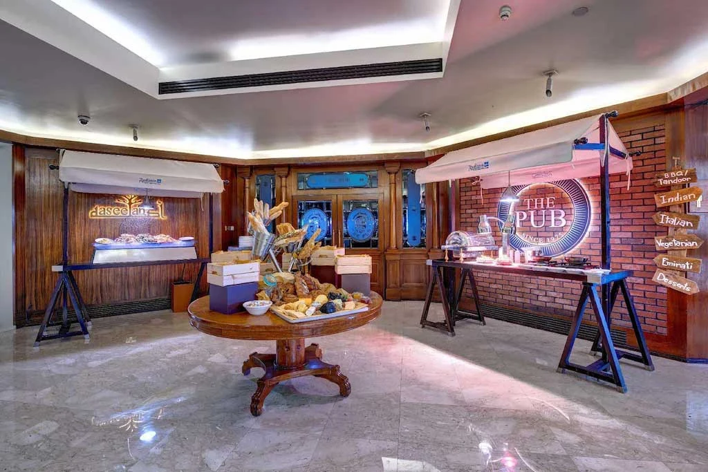 Radisson Blu Hotel Dubai buffet area with bread and food displays.