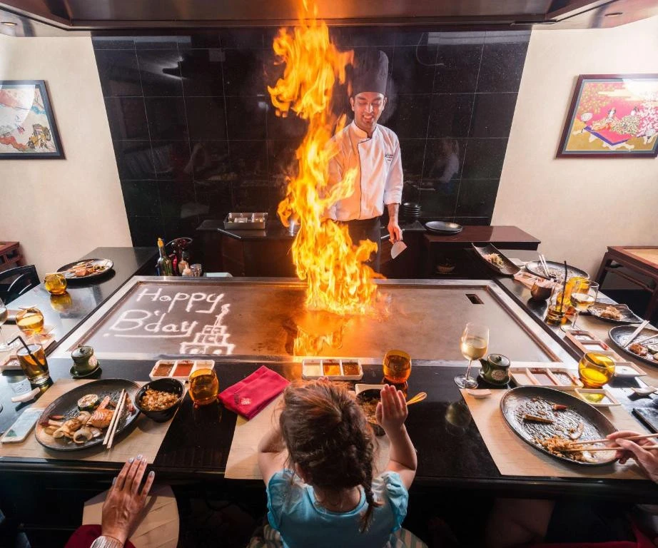 Chef performing teppanyaki with flames at Radisson Blu Hotel, Dubai.